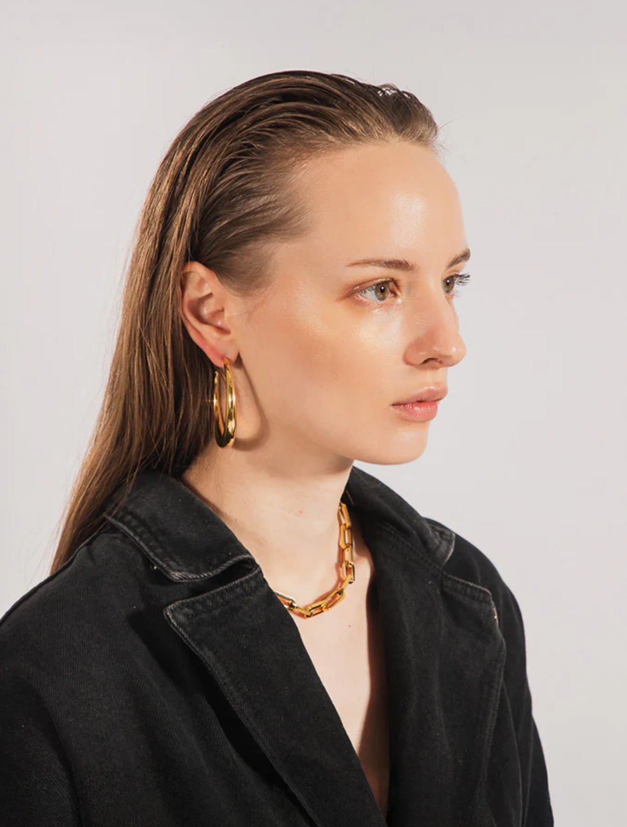 Aretes tipo candonga Afti Hoops en baño de oro con diseño orgánico para mujer – Sofía Llanos | Casa Precis, Concept Store. Segundo plano.