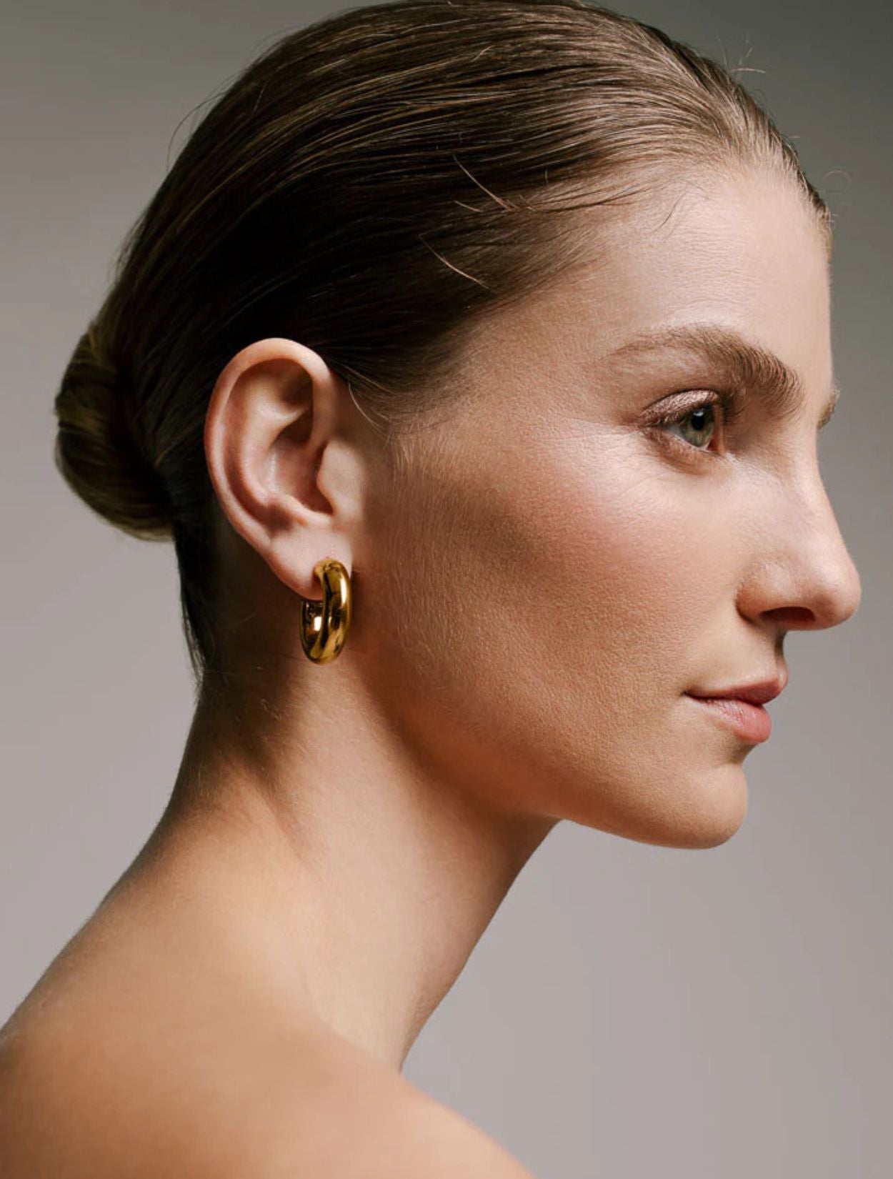 Aretes tipo candonga Fixi Hoops dorados con baño de oro y diseño arquitectónico para mujer – Sofía Llanos | Casa Precis, Concept Store. Segundo plano.