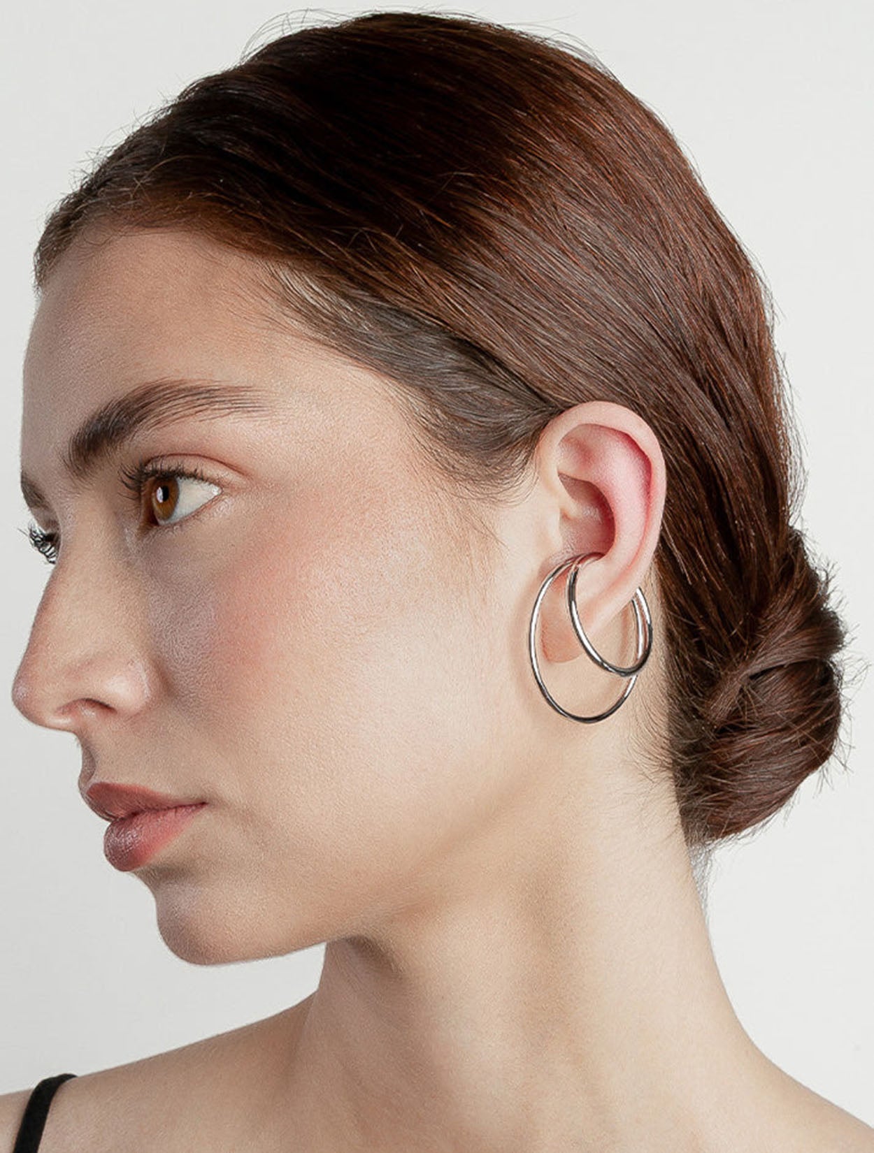 Earcuff maxi Nethos en acrílico iridiscente con diseño envolvente y efecto holográfico para mujer – Sofía Llanos | Casa Precis, Concept Store. Segundo plano.