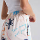 Pantalón recto en dril color marfil con bordado Happy Life para mujer – Juliana Sanchez | Casa Precis, Concept Store. Tercer plano.