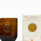 Vela artesanal aromática Té Blanco & Mandarina de 85gr de la marca colombiana Gandha. Objeto original de lujo colombiano y esencia de marcas colombianas para el hogar, disponible en nuestra concept store de bienestar.