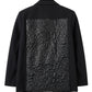 Twiggy Blazer de la marca Décadas en color negro con detalle posterior abullonado en cuero sintético y bordado de flor blanca – Blazer sastrero de diseño de autor hecho en Colombia | Casa Precis, Concept Store