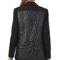 Twiggy Blazer de la marca Décadas en color negro con detalle posterior abullonado en cuero sintético y bordado de flor blanca – Blazer sastrero de diseño de autor hecho en Colombia | Casa Precis, Concept Store