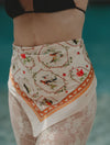 Pareo de playa Bandana Beige Pájaros de la marca Flor Amazona con estampado gráfico verde de diseño de autor multifuncional – Ropa de playa de lujo hecha en Colombia | Casa Precis, Concept Store