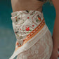 Pareo de playa Bandana Beige Pájaros de la marca Flor Amazona con estampado gráfico verde de diseño de autor multifuncional – Ropa de playa de lujo hecha en Colombia | Casa Precis, Concept Store